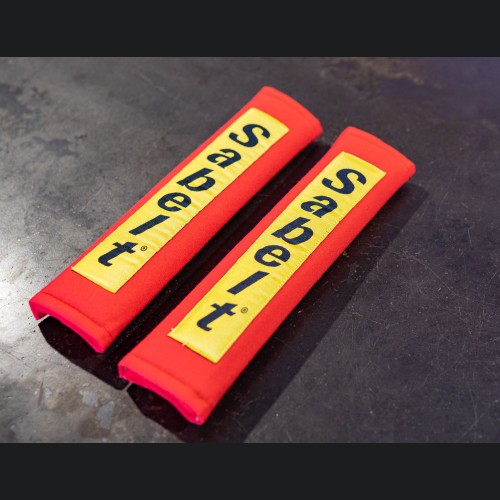 Seat Belt Shoulder Pads (set of 2) - w/ Yellow Sabelt Logo - Red Pads